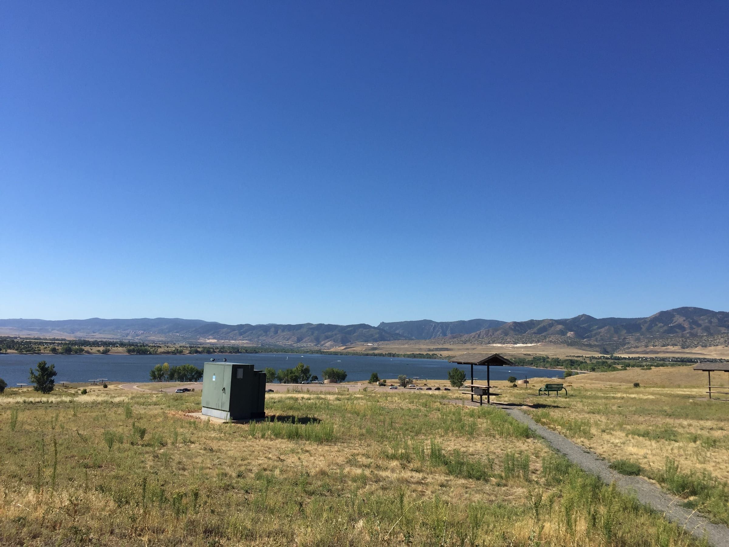 Chatfield Reservoir in September: a deep blue sky over the water, with dry golden hills along the far shore